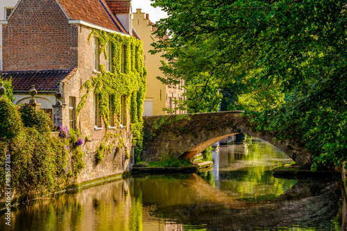 Bruges (Brugge) cityscape with water canal and bridge photo