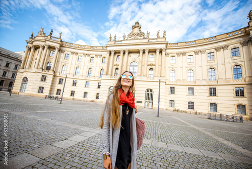 Young woman student walking near the old library in Berlin city