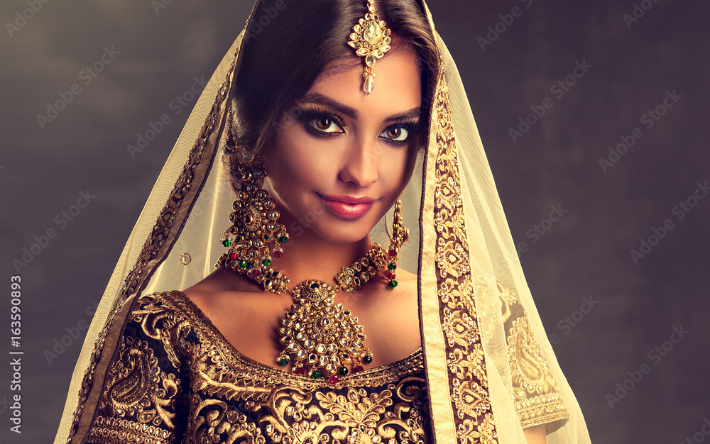 Portrait of beautiful indian girl. Young hindu woman model with golden  kundan jewelry set . Traditional Indian costume lehenga choli . Stock Photo  | Adobe Stock