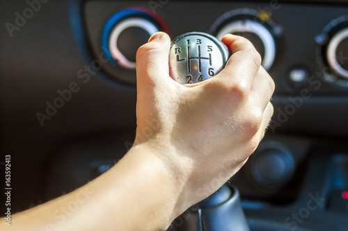 Foto Driver hand shifting gear shift knob manually, selective focus
