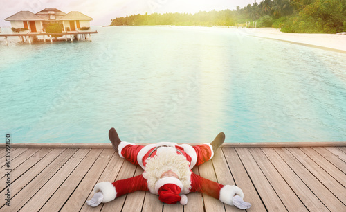 Santa Claus lying on deck n...