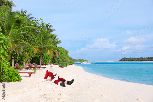 Santa Claus relaxing on sea...