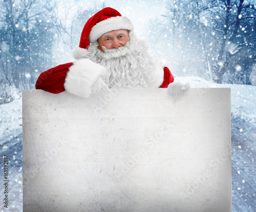 Santa Claus with blank post...