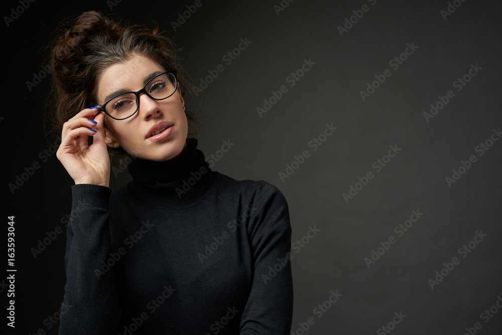 business fashion girl with glasses on dark gray background business fashion girl with glasses on dark gray background