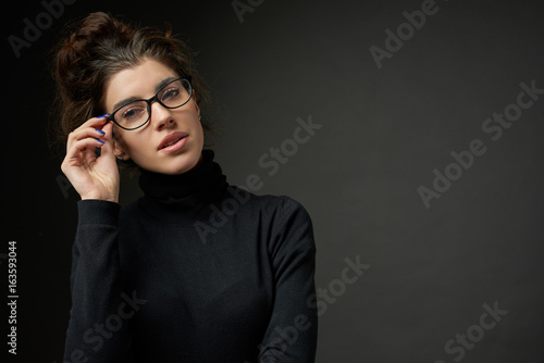 business fashion girl with glasses on dark gray background