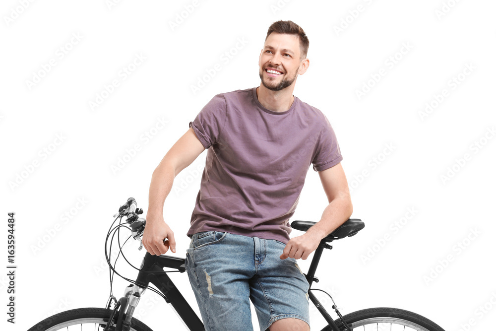 Handsome young man with bicycle on white background