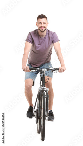 Handsome young man riding b...