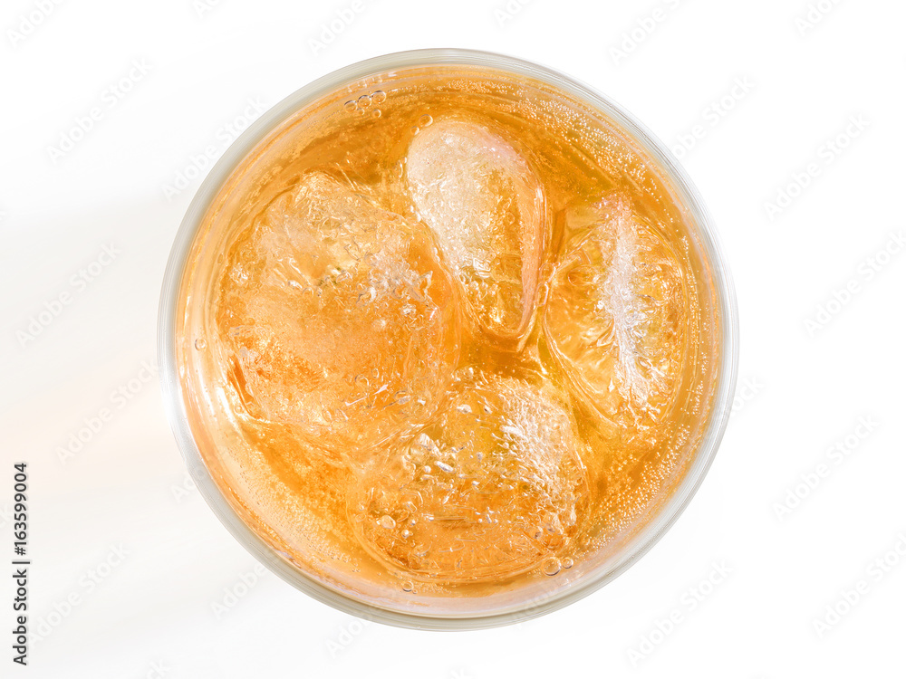 Orange drink with ice top view.
