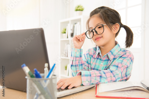 seriously and focused kid looking at laptop