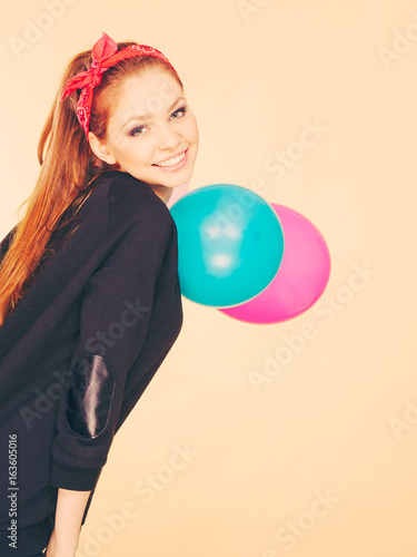 Smiling crazy girl having fun with balloons. © anetlanda
