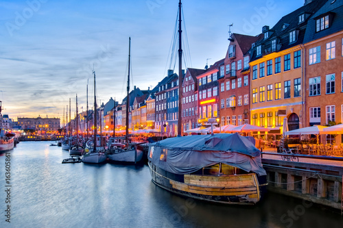 Canvas Print Nyhavn with its picturesque harbor with old sailing ships and colorful facades o