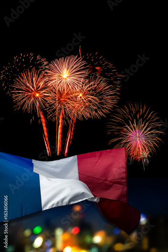 Beautiful holiday fireworks and france flag with (bokek background) blured cityscapes in night La F?te Nationale (Bastille Day) is celebration of french national holiday photo