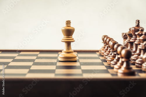 Chess on board  white backgroung. Confrontation concept