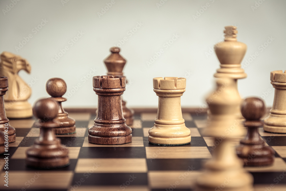 Chess on board white backgroung. Confrontation concept Chess on board white backgroung. Confrontation concept