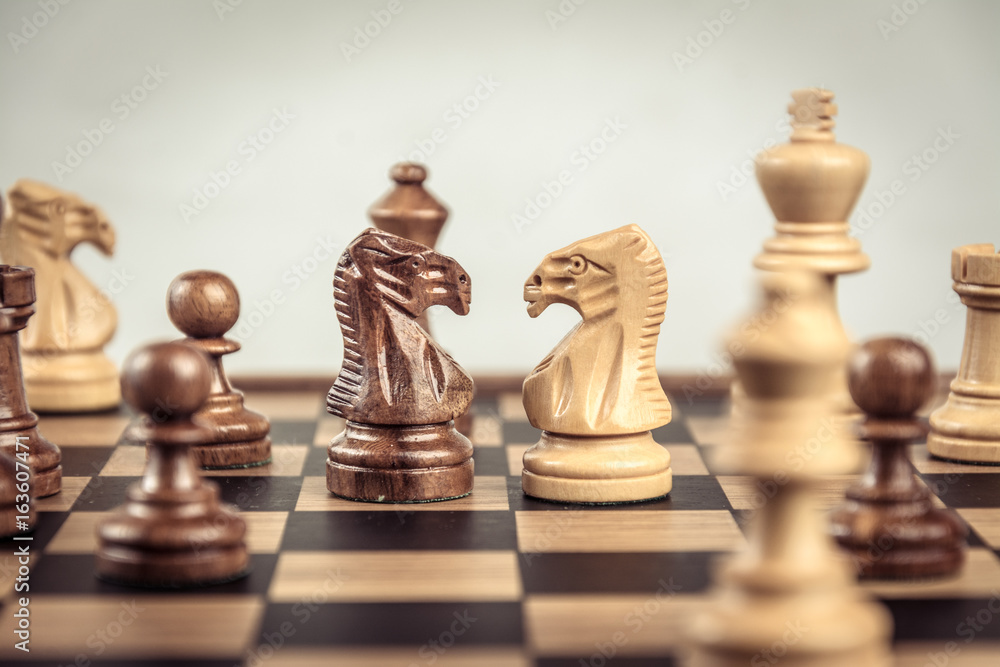 Chess on board white backgroung. Confrontation concept Chess on board white backgroung. Confrontation concept