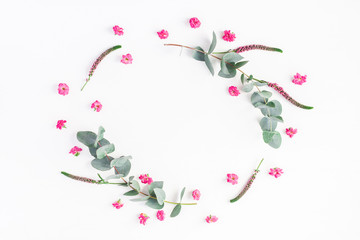 Flowers composition. Frame made of pink flowers and eucalyptus branches on white background. Flat lay, top view, copy space