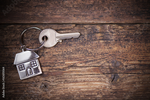  house key ring and old wood background