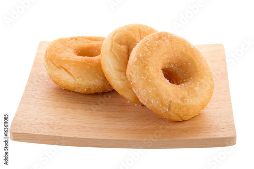 Sugary donuts on a wooden plate isolated on a white background © kaiskynet