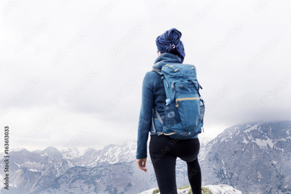 Female hiker standing on the top of the mountain with beatufil panorama below