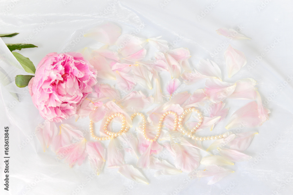 Delicate background with pink peony, peony petals and pearls Delicate background with pink peony, peony petals and pearls
