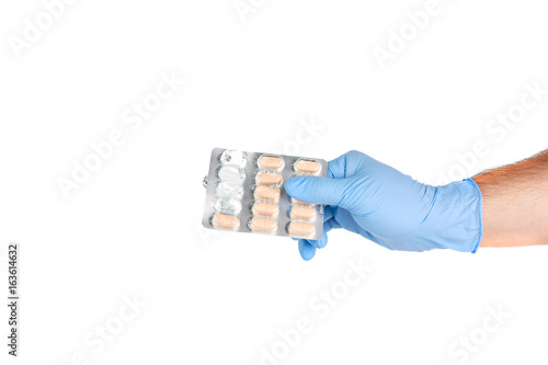 Hand With Medical Gloves Holding Blister With Medicine Pills