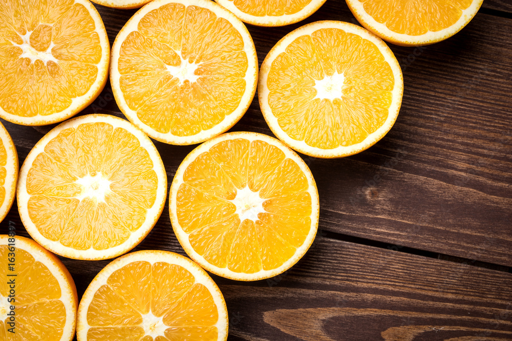 Half cut oranges on an old wooden table Half cut oranges on an old wooden table