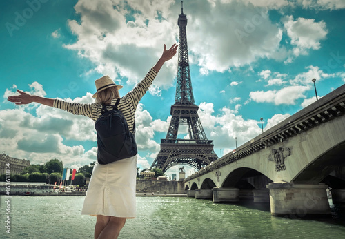 Photography Woman tourist selfie near the Eiffel tower in Paris under sunlig