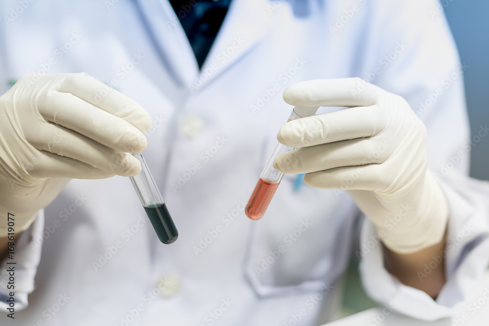 Laboratory technician injecting liquid into a microtiter plate, Scientist working at the laboratory, blood analysis, Vintage color. Laboratory technician injecting liquid into a microtiter plate, Scientist working at the laboratory, blood analysis, Vintage color.