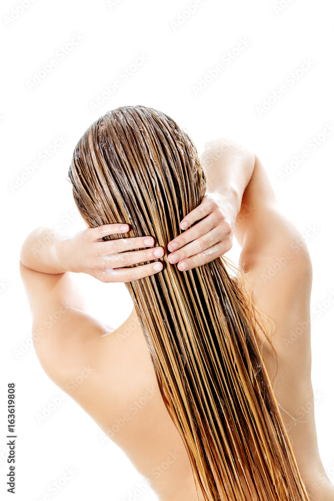 Naklejka premium Photo of woman applying hair conditioner.