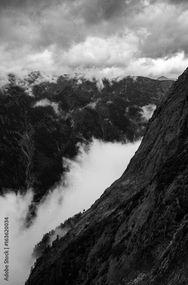 Clouds are forming in the gorge between Alps in Austria