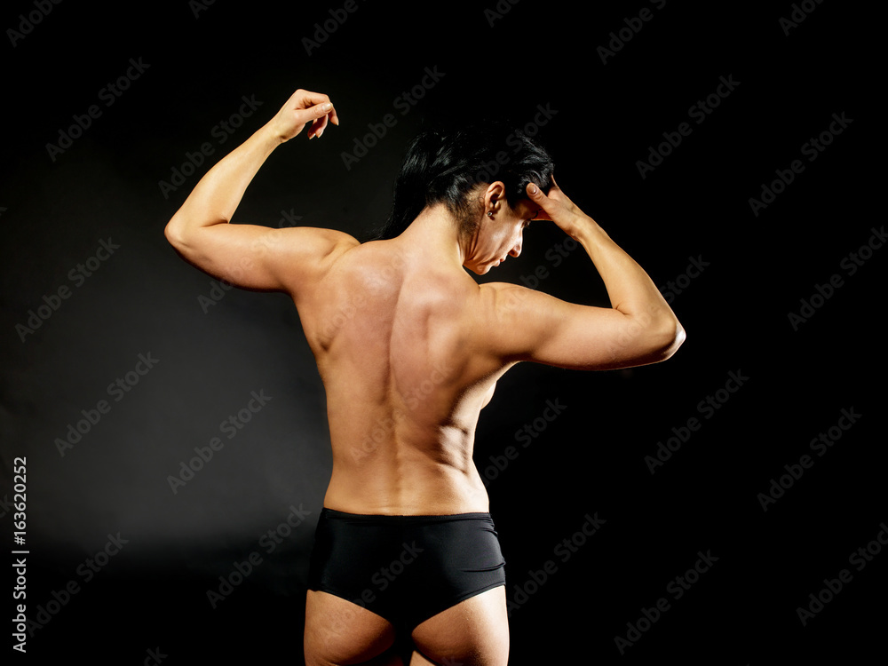 Muscular bodybuilder woman showing her muscles. Muscular bodybuilder woman showing her muscles.