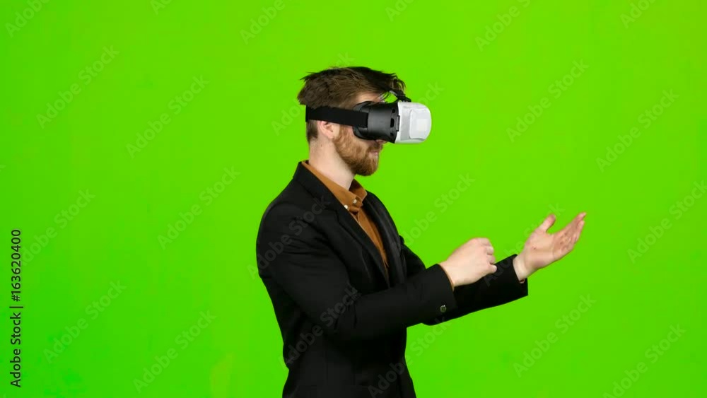 Businessman in glasses of virtual reality, typing text. Green screen Businessman in glasses of virtual reality, typing text. Green screen