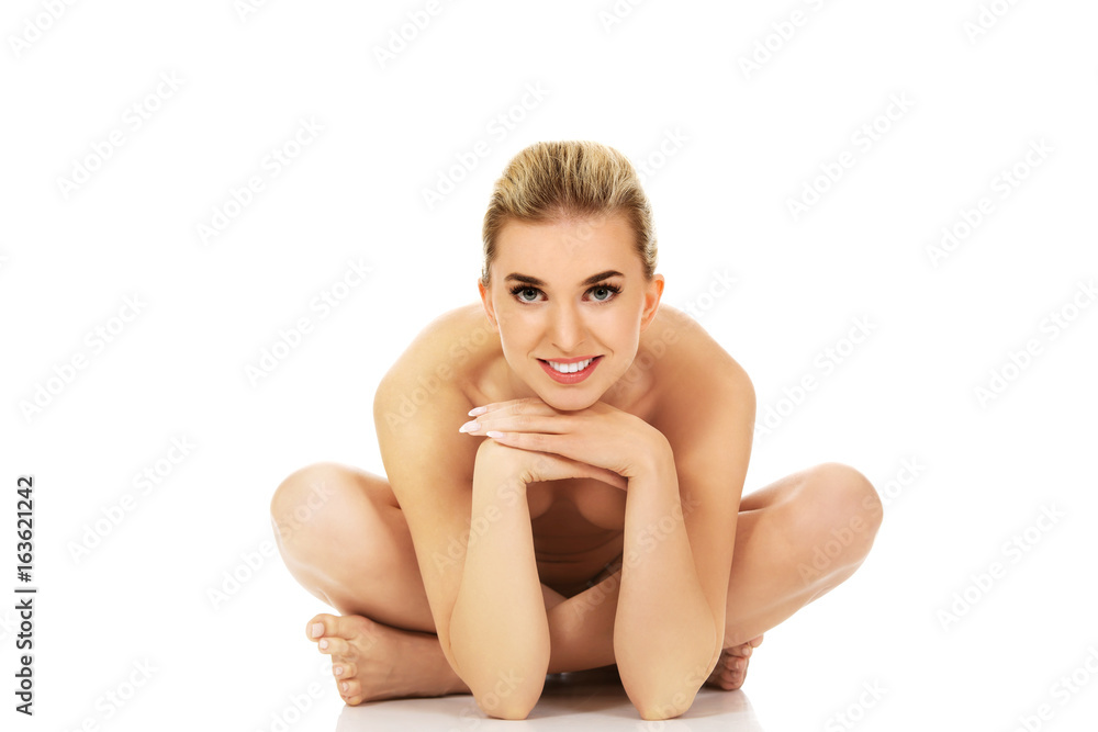 Young naked woman sitting on the floor Young naked woman sitting on the floor