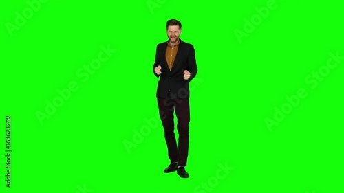 Guy is happy with his victories, he is happy. Green screen photo