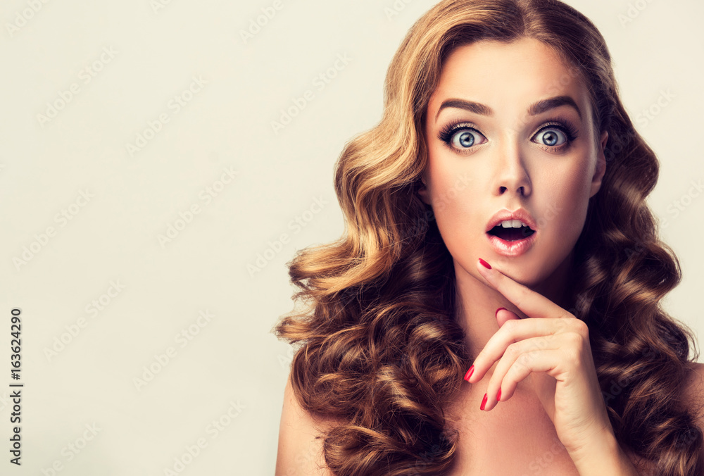 Shocked and surprised girl presenting your product . Curly hair woman amazed .Beautiful girl with curly hair and red nails manicure. Expressive facial expressions
Shocked and surprised girl presenting your product . Curly hair woman amazed .Beautiful girl with curly hair and red nails manicure. Expressive facial expressions