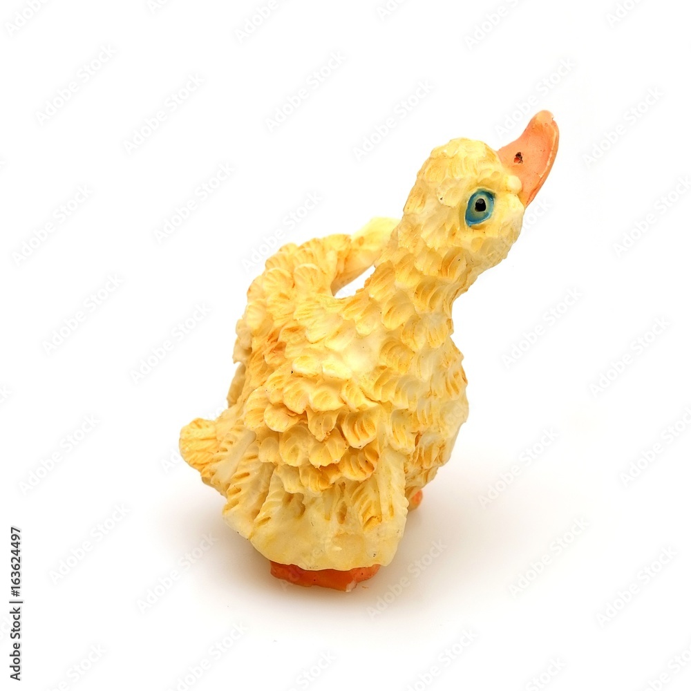 Ceramic yellow gosling on a white background in various angles Ceramic yellow gosling on a white background in various angles