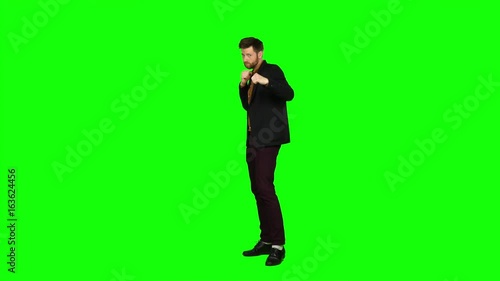 Man is standing in a rack and boxing. Green screen photo