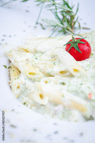 Penne pasta with cherry tomato closeup