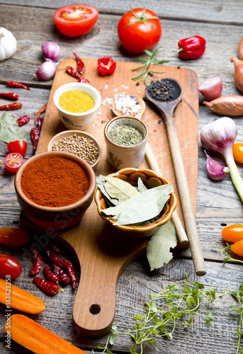 Spices and vegetables on wooden board