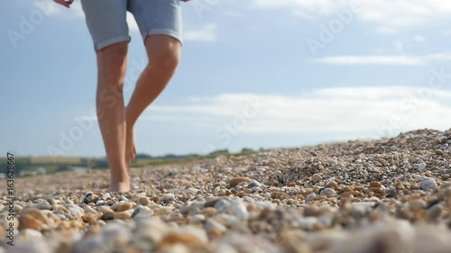 Walking along beach, slow motion photo
