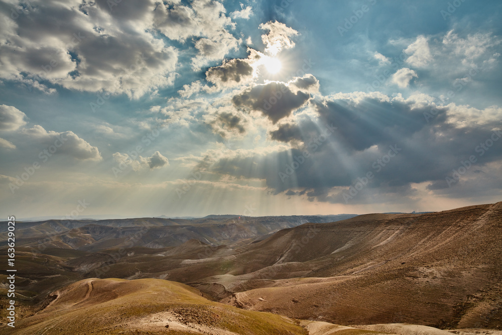 Fototapeta premium Light falling trough clouds at the Israeli mountains