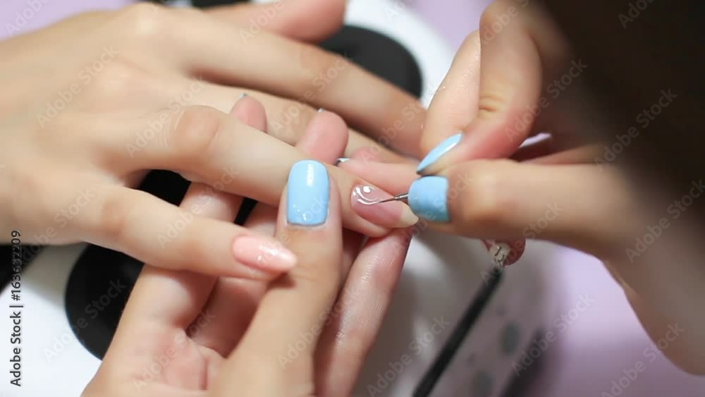 The girl is doing a manicure. Beautiful female hands. Beautiful nails. The girl is doing a manicure. Beautiful female hands. Beautiful nails.