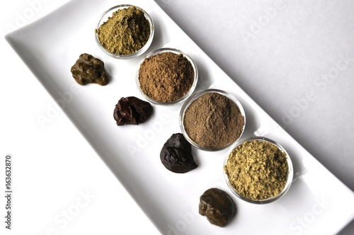A selection of various natural henna (Lawsonia inermis) hair color dyes wet mixture isolated on white