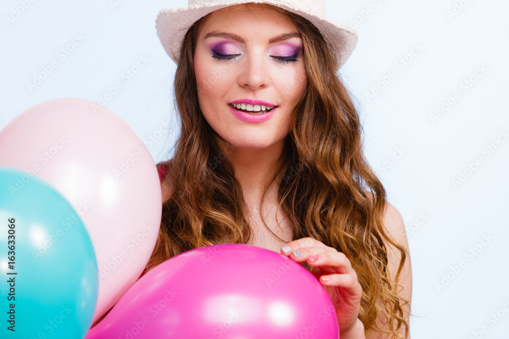Woman playing with many colorful balloons Woman playing with many colorful balloons