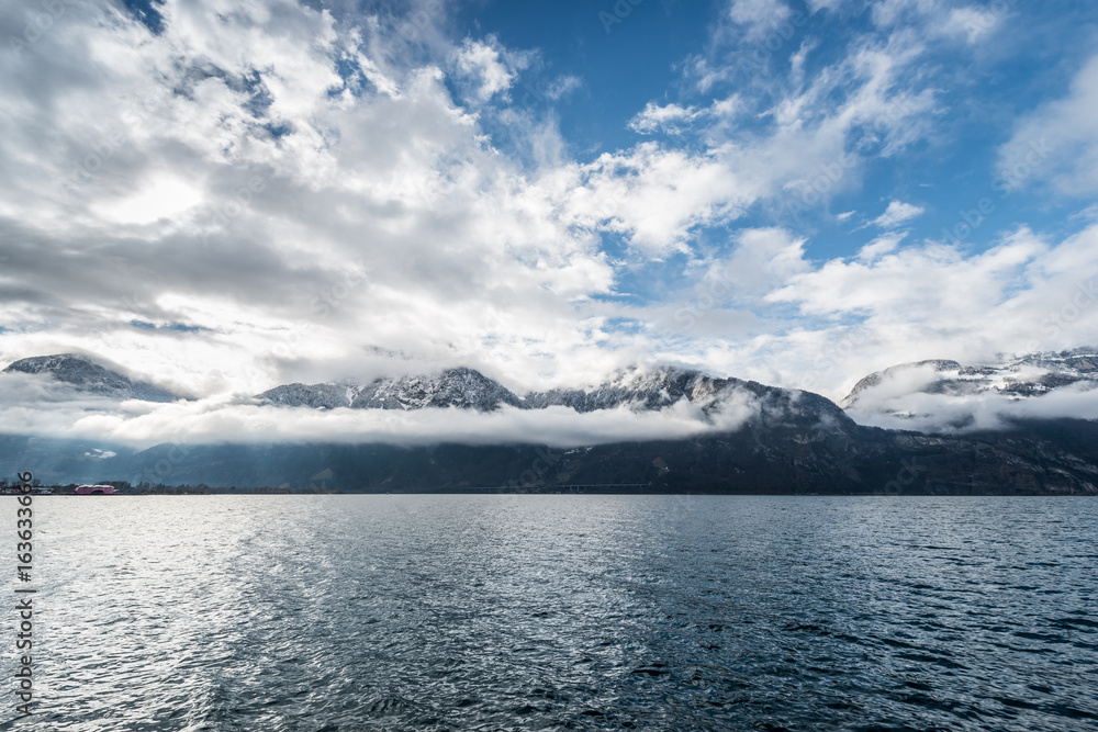 Mountainous landscape. Clouds above the lake and the tops of the mountains. Swiss Alps.