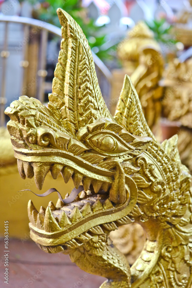 Fototapeta premium Golden Naga ladder sculpture in Lao temple, Laos