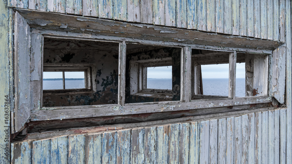 Abandoned military watchtower in Estonian small rural town Paldiski old window frames and peeling dry paint Abandoned military watchtower in Estonian small rural town Paldiski old window frames and peeling dry paint