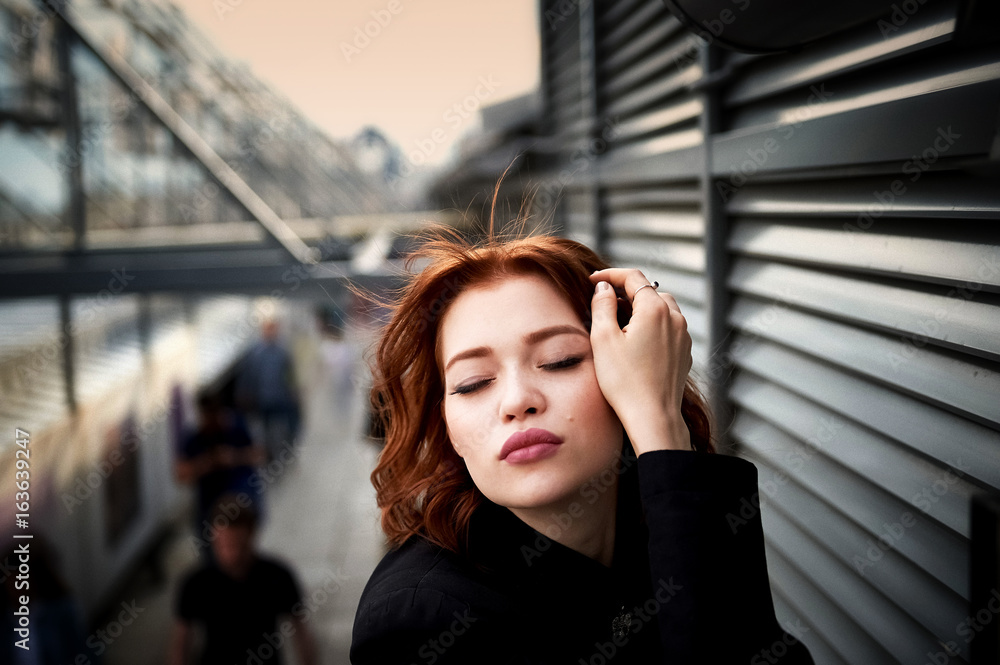 Beautiful red-haired girl with plump lips. Walking around the city. A natural beauty. Roof. Ginger