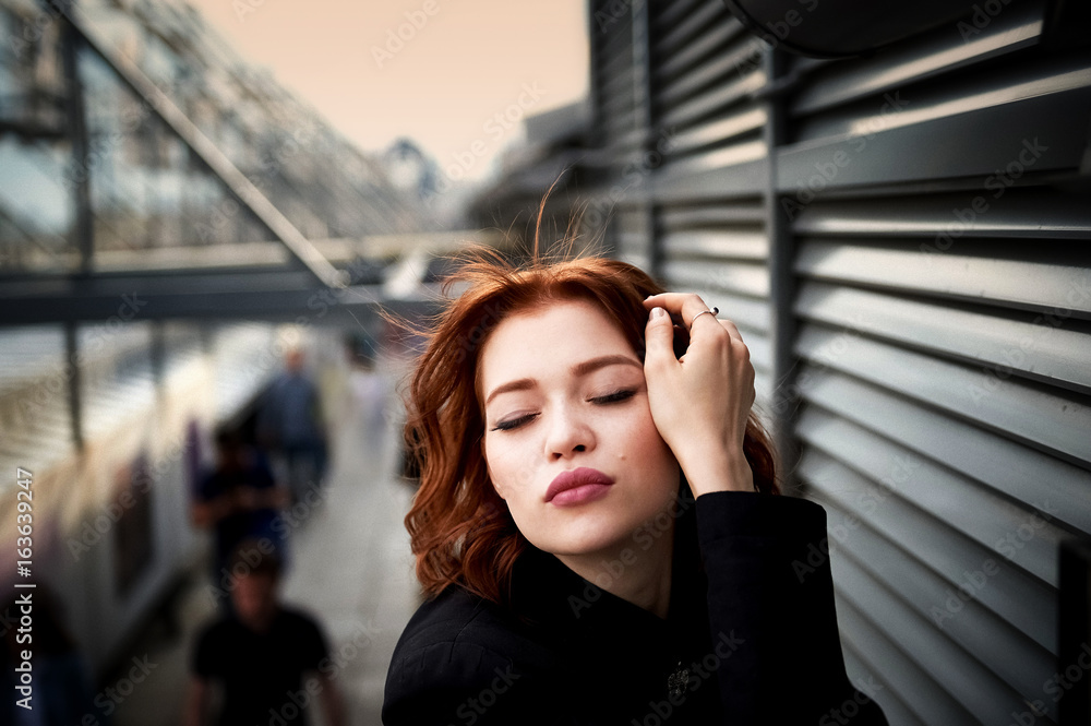 Beautiful red-haired girl with plump lips. Walking around the city. A natural beauty. Roof. Ginger Beautiful red-haired girl with plump lips. Walking around the city. A natural beauty. Roof. Ginger
