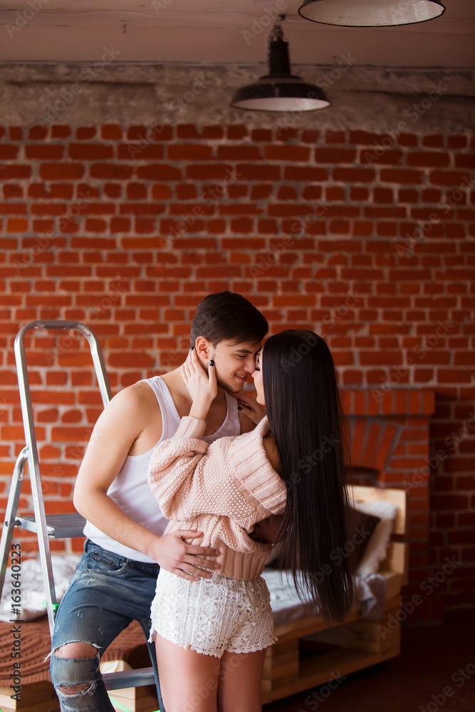 Romantic couple. Passion time. Young loving couple embracing and looking to each other at home. Romantic couple. Passion time. Young loving couple embracing and looking to each other at home.